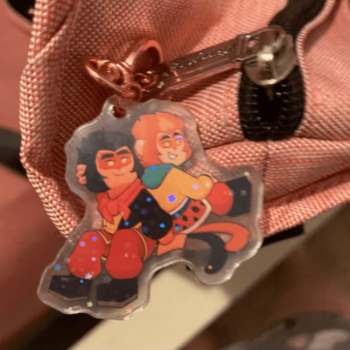 One side of the Shadowpeach charm, which shows young Macaque and Wukong happy together